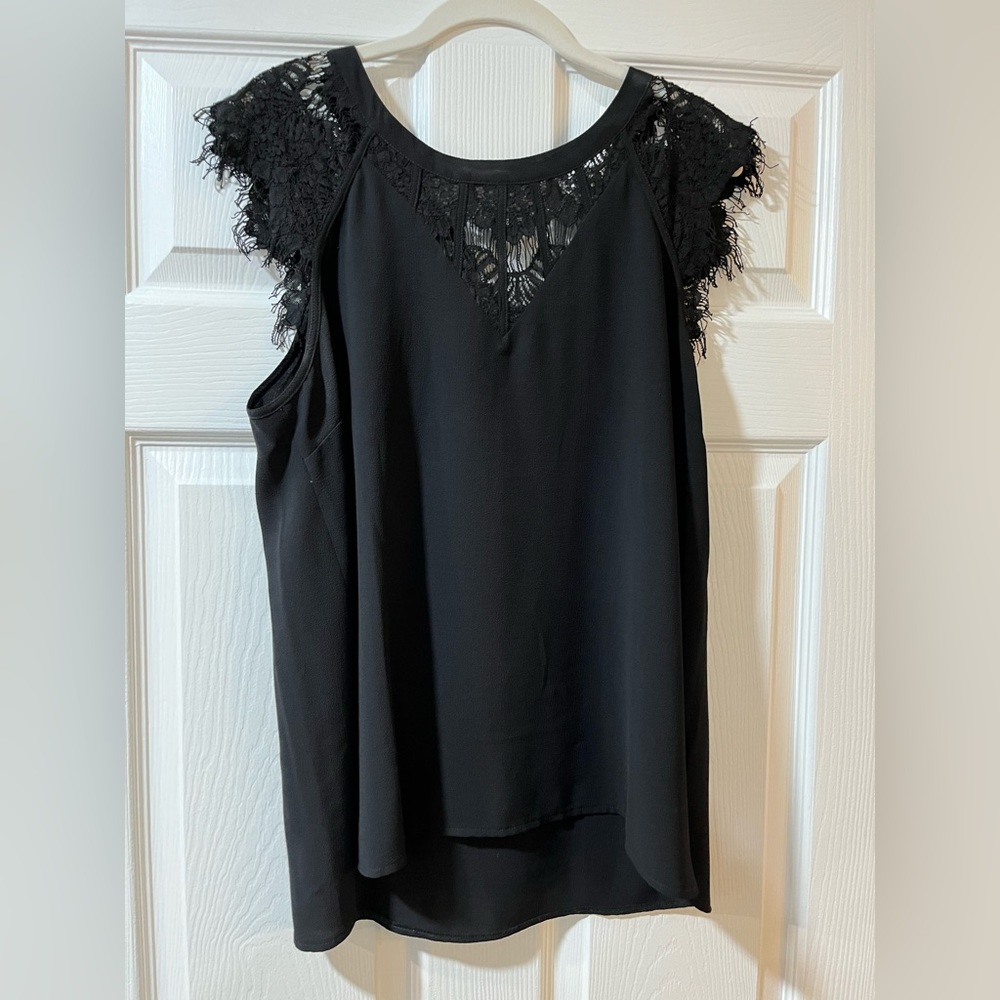 Brixon Ivy blouse with lace detail on neckline and sleeves.
